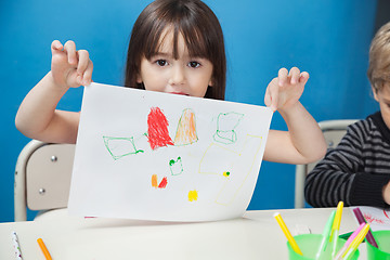 Image showing Girl Holding Drawing Paper In Art Class