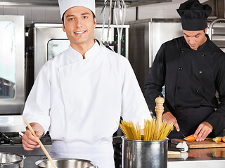 Image showing Male Chef Cooking Food In Kitchen