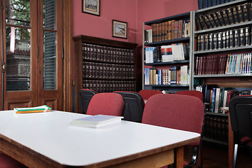 Image showing Chairs At Table With Bookshelf In Library