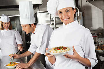 Image showing Happy Female Chef Presenting Pasta In Kitchen