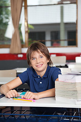 Image showing Schoolboy With Books And Globe At Desk