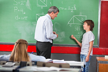 Image showing Schoolboy Asking Question To Teacher While Solving Mathematics