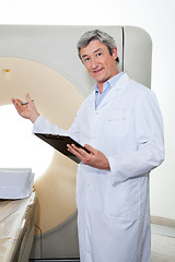 Image showing Doctor Presenting The CT Scan Machine
