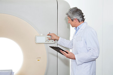 Image showing Doctor Operating CT Scan Machine