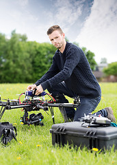 Image showing Young Technician Assembling UAV in Park