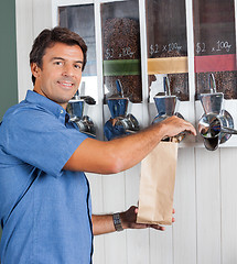 Image showing Man Choosing Coffee From Vending Machine