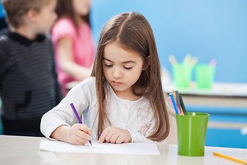 Image showing Cute Girl Drawing With Sketch Pen In Classroom