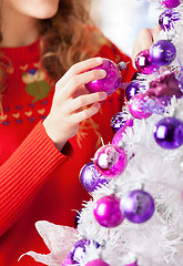 Image showing Owner Decorating Christmas Tree With Balls