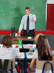 Image showing Teacher Pointing At Students In Classroom