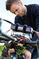 Image showing Technician Fixing Camera On UAV Drone