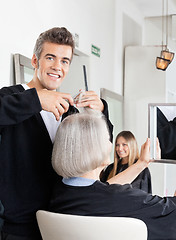 Image showing Hairdresser Cutting Client's Hair At Salon