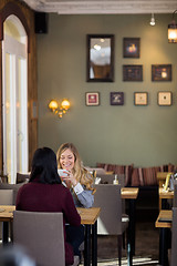 Image showing Happy Young Woman Having Coffee With Friend