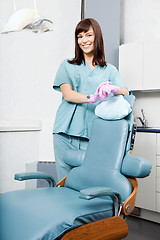 Image showing Smiling Female Dentist Standing By Dental Chair At Clinic