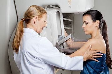 Image showing Doctor Assisting Patient Undergoing Mammogram