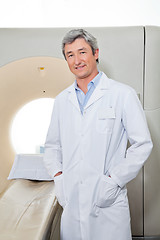 Image showing Doctor Standing Next To CT Scanner