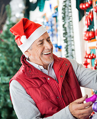 Image showing Owner In Santa Hat Working At Christmas Store