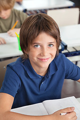 Image showing Cute Schoolboy Smiling In Classroom