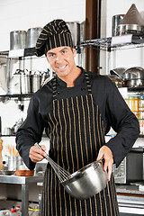 Image showing Male Chef Holding Wire Whisk And Mixing Bowl