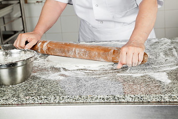 Image showing Female Chef Rolling Dough In Kitchen