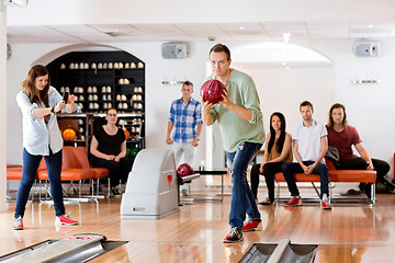 Image showing Man Bowling With Friend Photographing At Club