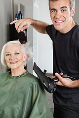 Image showing Hair Stylist Blow Drying Senior Woman's Hair