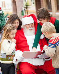 Image showing Santa Claus And Children Reading Book