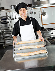 Image showing Male Chef Showing Baked Bread Loafs