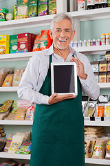 Image showing Male Owner Showing Digital Tablet In Store