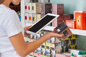 Image showing Woman Scanning Barcode Through Digital Tablet