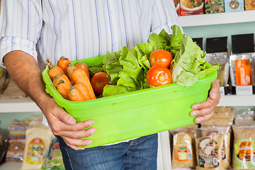 Image showing Midsection Of Man Holding Vegetable Basket