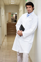 Image showing Serious Male Doctor Holding Book