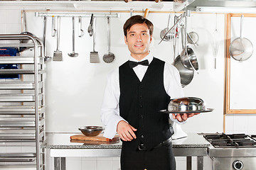 Image showing Young Waiter With Cloche Lid Cover And Tray