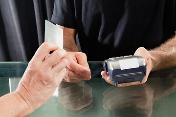 Image showing Customer Paying Through Credit Card To Hairstylist