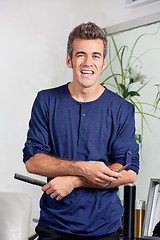 Image showing Male Hairdresser Holding Scissors And Comb In Salon