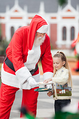 Image showing Girl Taking Cookies From Santa Claus