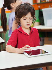Image showing Little Boy Using Digital Tablet In Kindergarten
