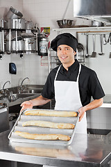 Image showing Male Chef Presenting Loafs In Kitchen