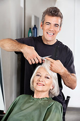 Image showing Hairdresser Cutting Client's Hair At Salon