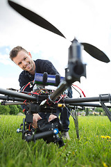 Image showing Technician Assembling Camera On UAV Drone