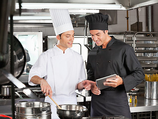 Image showing Male chefs Preparing Food Together