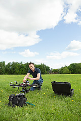 Image showing Technician Assembling UAV Helicopter