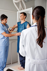 Image showing Doctor With Technician Assisting Patient For X-ray