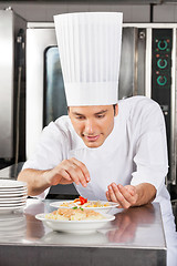 Image showing Chef Adding Spices To Dish