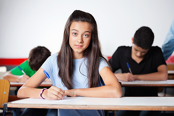 Image showing Portrait Of Teenage Schoolgirl Writing At Desk