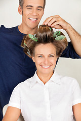 Image showing Client With Hairstylist Rolling Her Hair