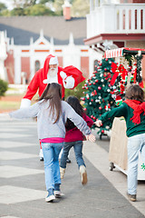 Image showing Children Running To Embrace Santa Claus