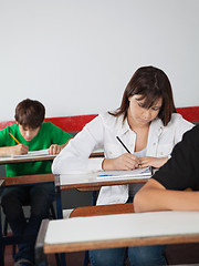 Image showing Schoolgirl Writing Paper At Desk