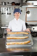 Image showing Female Chef Presenting Baked Loafs