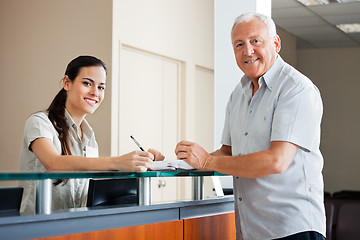 Image showing Senior Man Standing At Hospital Reception