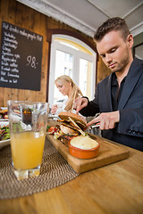 Image showing Businessman Having Food With Colleague